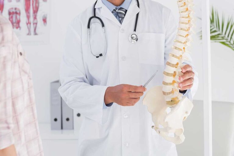 A practitioner gently adjusting a patient’s spine next to a therapist massaging a person’s neck and shoulders.